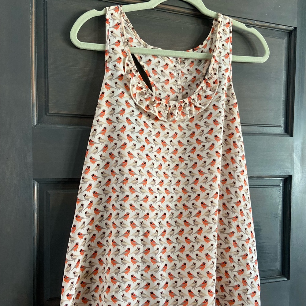 Women’s tank with ruffles on the back.